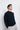 Unfeigned dark navy crewneck merino knit on model half body