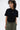 Unfeigned caviar basic t-shirt with logo on model half body studio