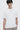 Unfeigned white basic t-shirt with logo on model half body studio
